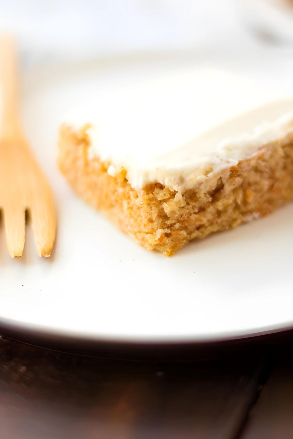 Slice of Carrot Cake Sheet Cake with Cream Cheese Icing on plate