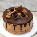 A chocolate layer cake with chocolate ganache drip and chocolate decorating the top.