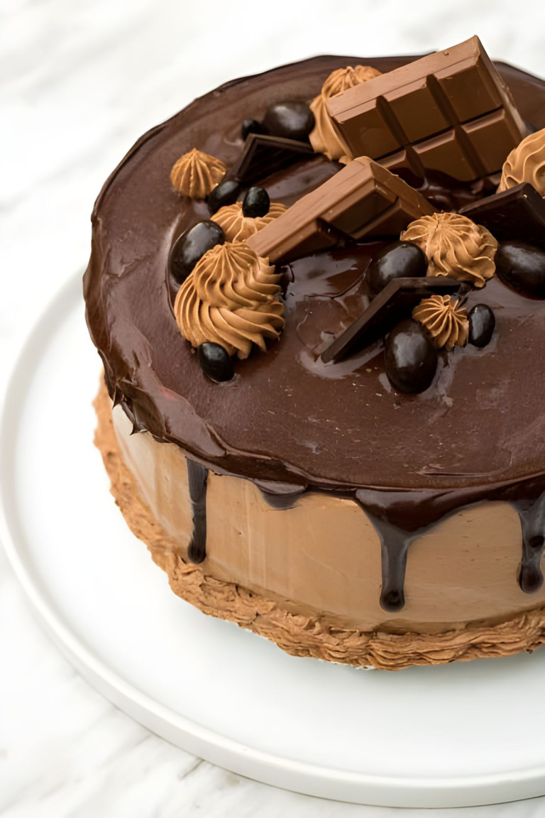 A chocolate layer cake with chocolate ganache drip and chocolate decorating the top.