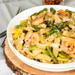 Shrimp, pasta, and asparagus in a bowl.