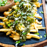 Spinach gravy on top of french fries.