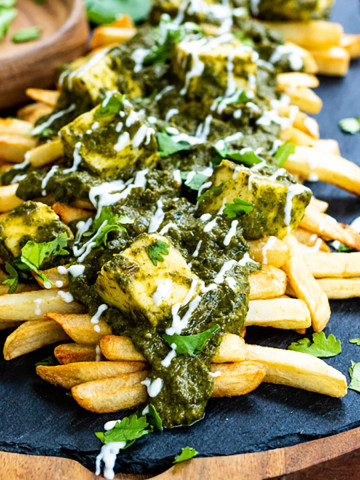 Spinach gravy on top of french fries.
