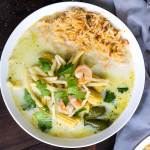 A coconut milk based soup in a bowl with rice.