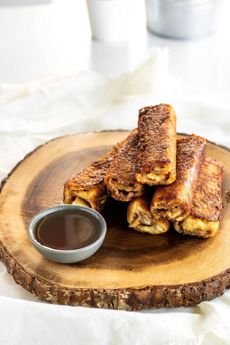 Peanut Butter Banana French Toast Roll-Ups on a wooden platter.