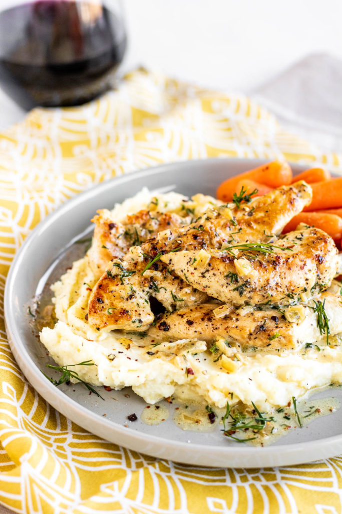Creamy Dill Chicken on a plate with potatoes and carrots
