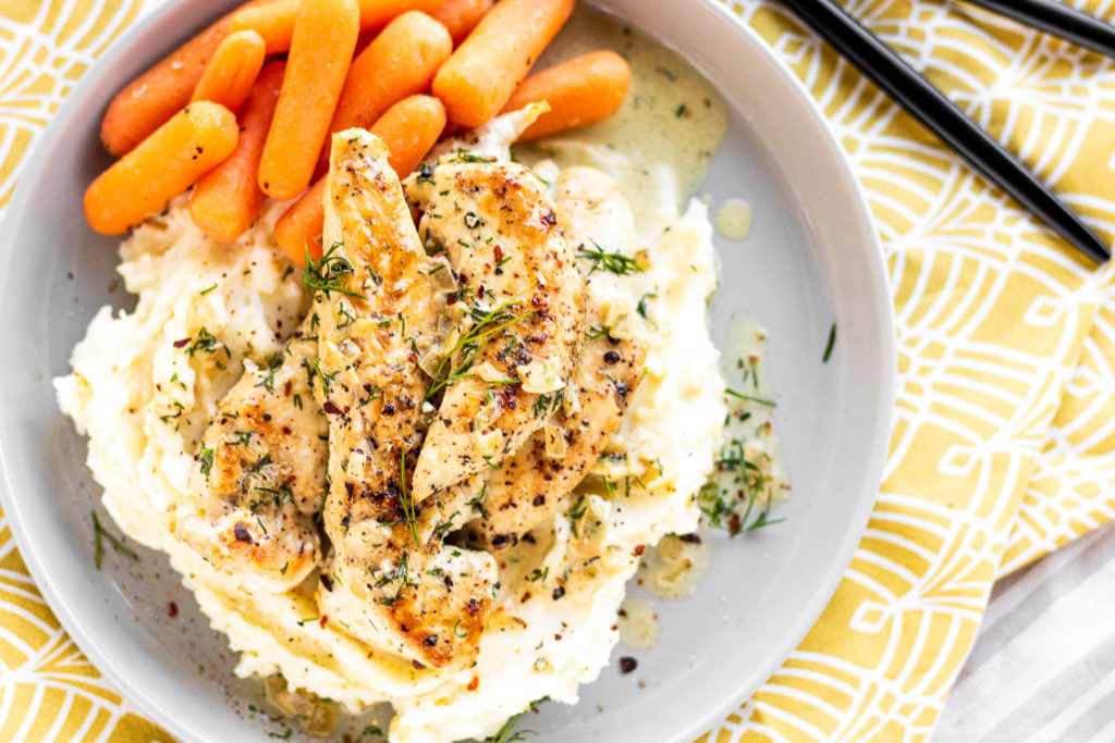 Creamy Dill Chicken on a plate with potatoes & carrots