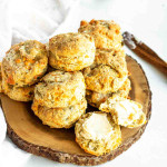 A pile of biscuits on a wooden platter.