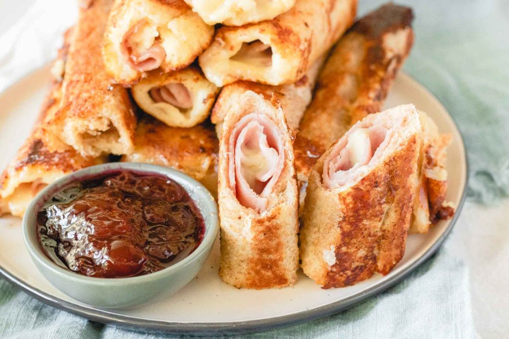 Monte Cristo Roll-Ups on a plate with jam
