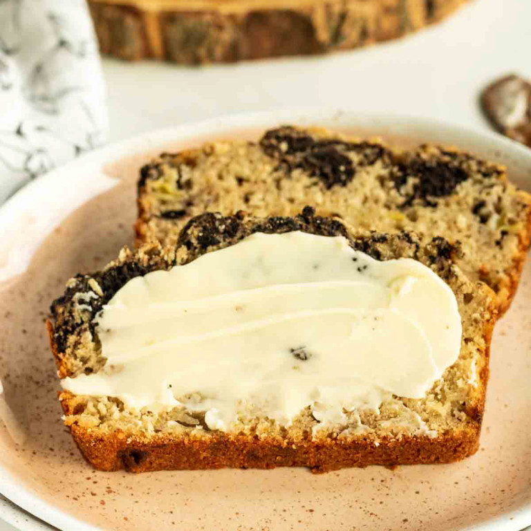 loaf of baked banana bread on a wood platter
