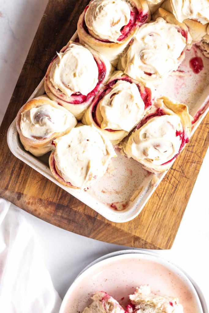 Cranberry Sweet Rolls in a pan with icing on top