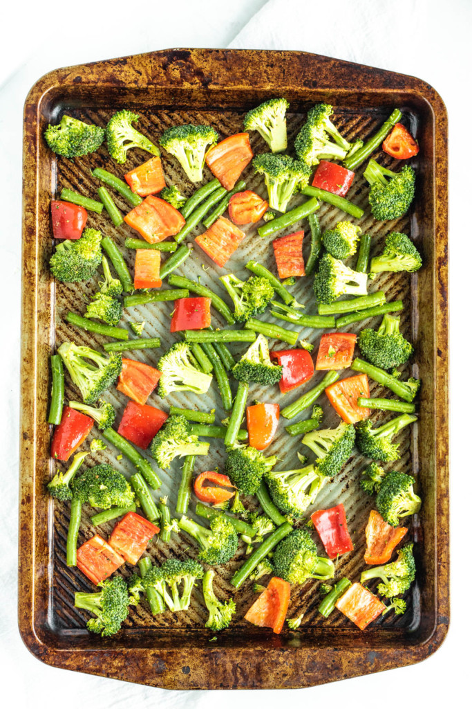 broccoli and red bell pepper on a sheet pan