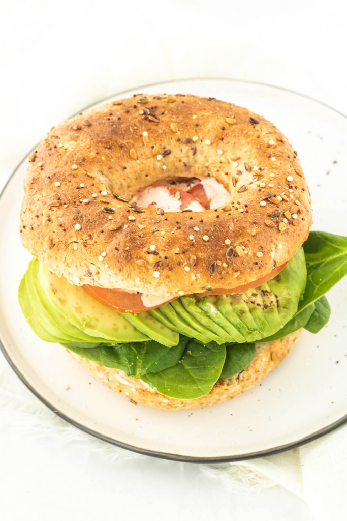 toasted bagel sandwich with tomato, avocado and spinach