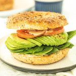 toasted bagel sandwich with tomato, avocado and spinach