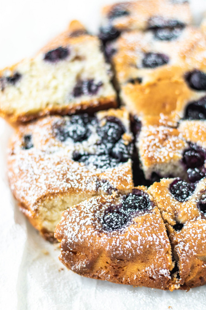 sliced blueberry cake with powdered sugar