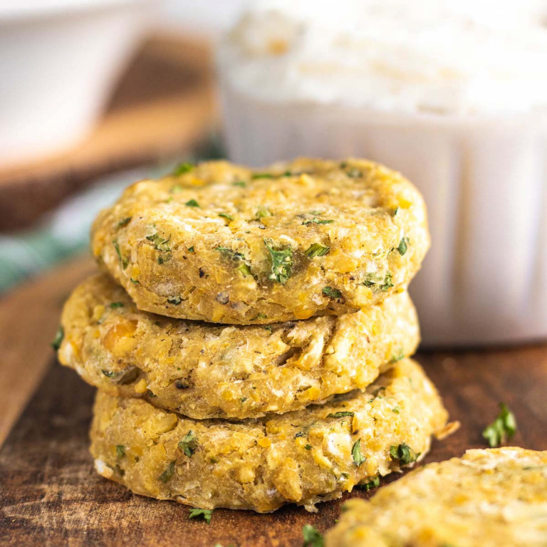 stacked chickpea patties on a wooden platter
