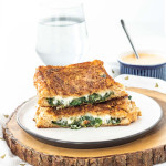 a grilled cheese sandwich cut in half on a plate