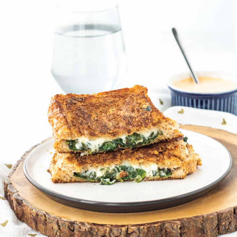 a grilled cheese sandwich cut in half on a plate