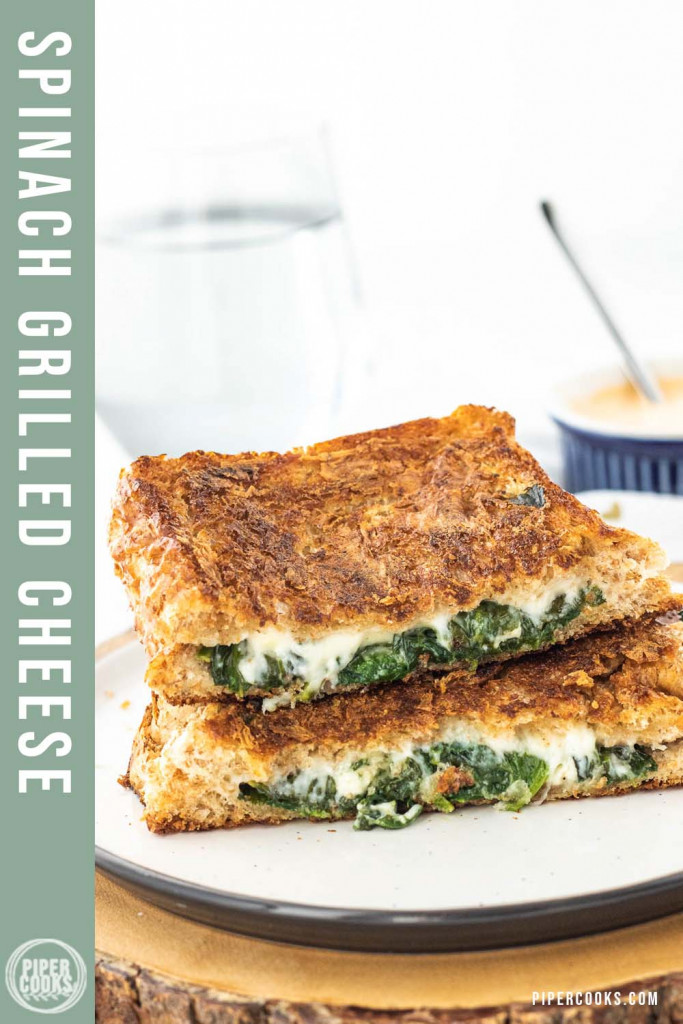 a grilled cheese sandwich cut in half on a plate with a text overlay for pinterest