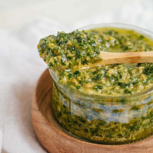 pesto in a small bowl with a spoonful of pesto resting on top