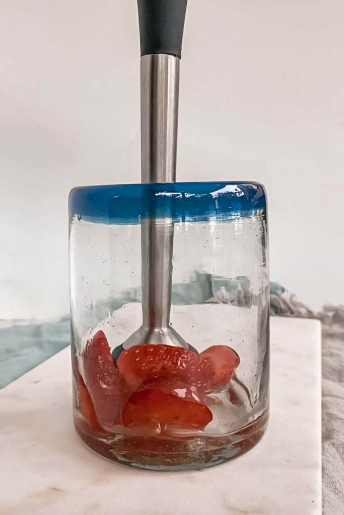 muddling strawberries and simply syrup
