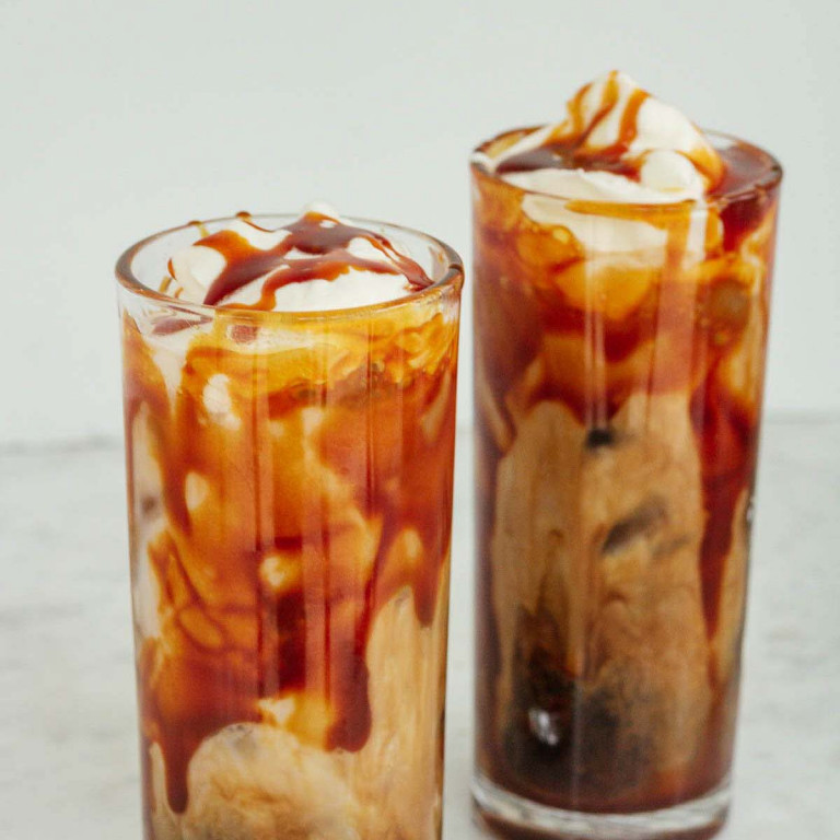 iced caramel latte with whipped cream and caramel sauce on top