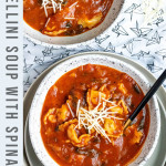tomato tortellini soup in a white speckled bowl with text overlay for pinterest