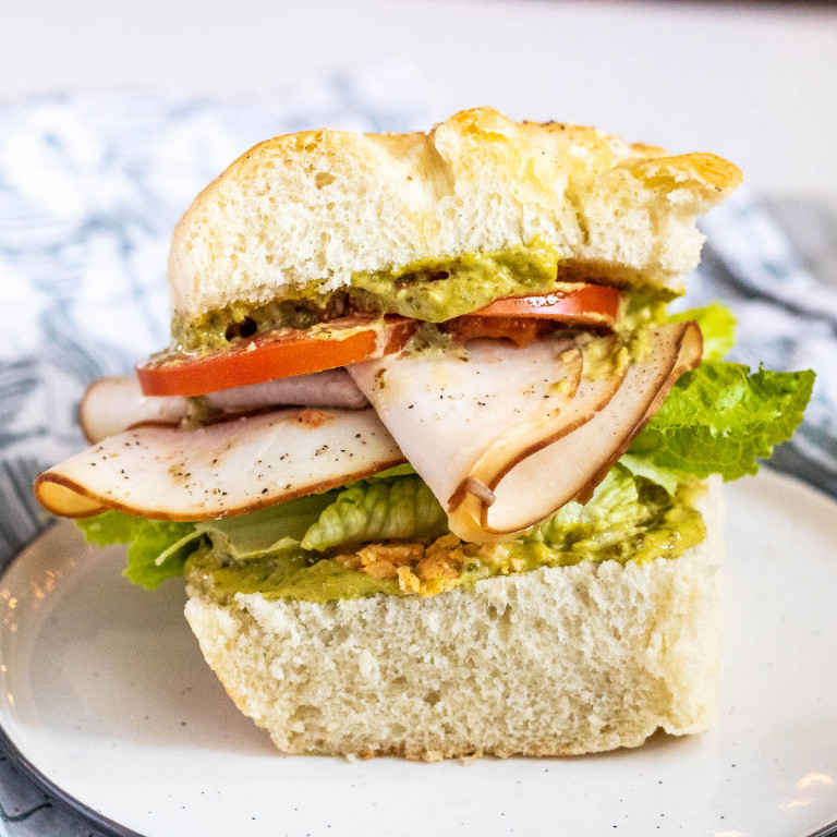 a turkey pesto sandwich on a plate