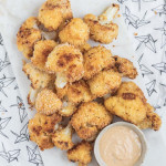 breaded cauliflower pieces on a marble slab with a text overlay for pinterest.