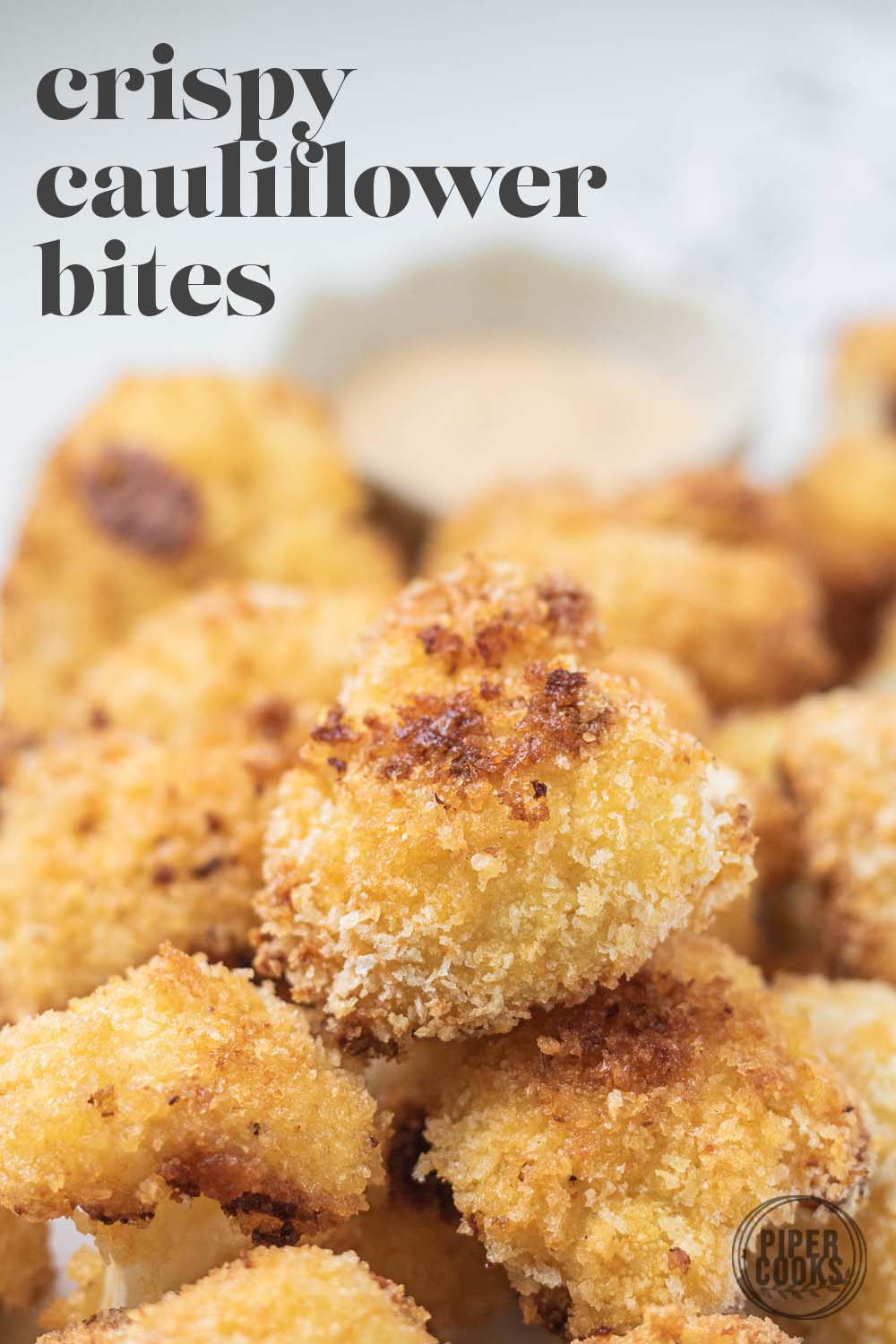 breaded cauliflower pieces on a marble slab with a text overlay for pinterest.