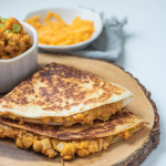 A quesadilla on a wooden board.