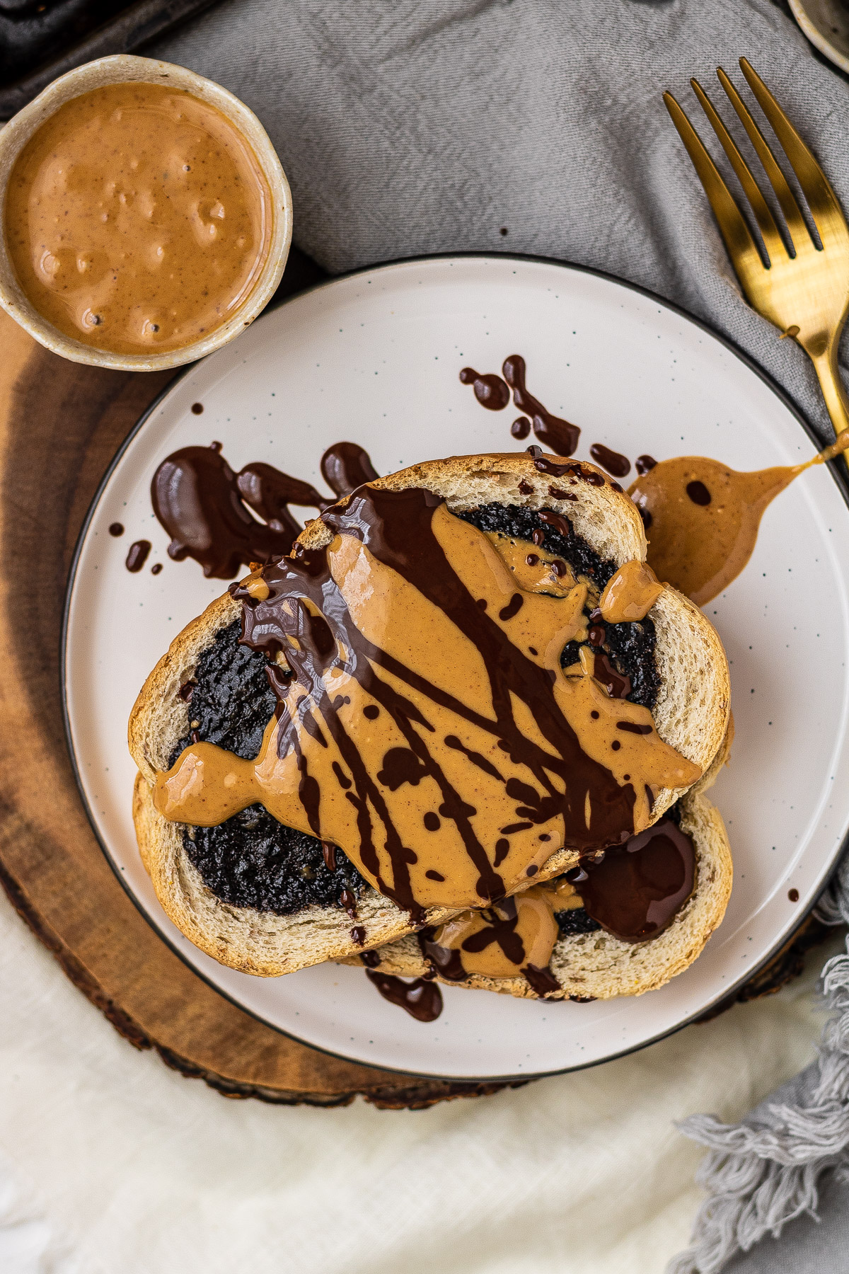 chocolate toast on a plate with peanut butter and chocolate drizzled on top.