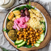 A mediterranean grain bowl with couscous, veggie balls and chickpeas in a bowl.