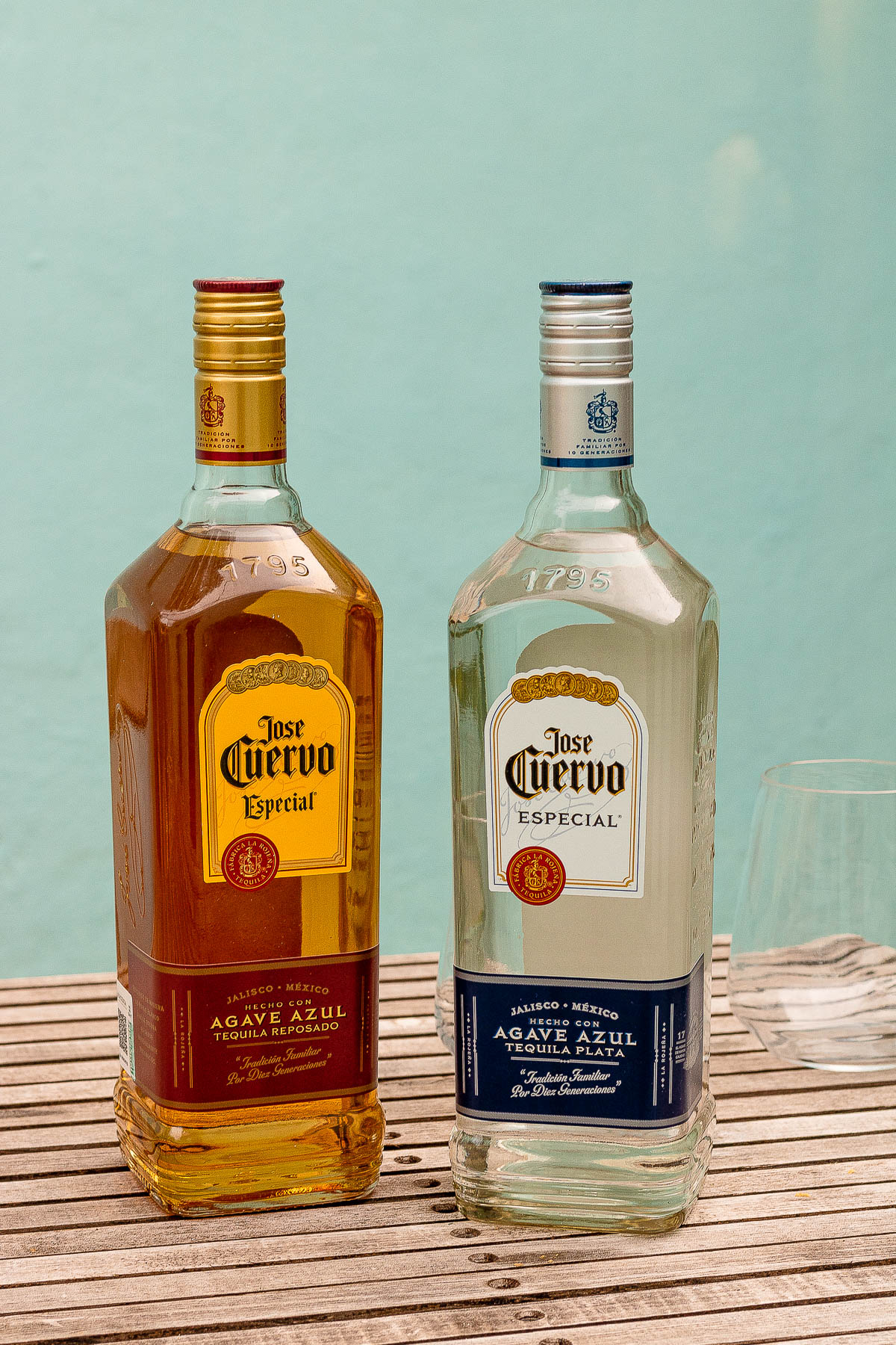 Two bottles of tequila, one aged and one silver.