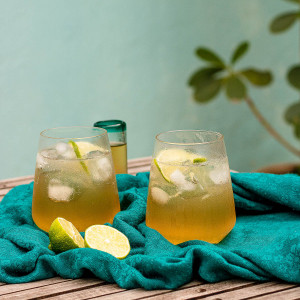 A Mexican mule cocktail in a clear glass with a twist of lime on top.