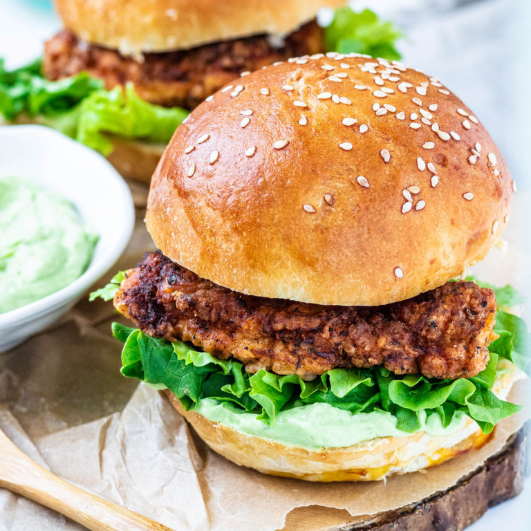 2 chicken burgers on a plate.