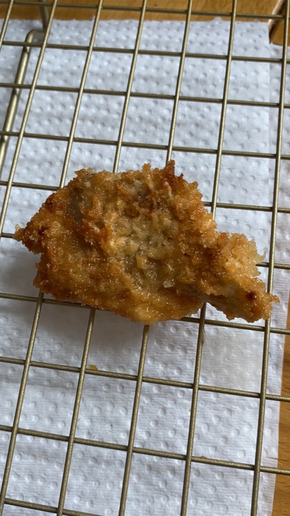 A fried oyster mushrooms on a cooling rack.