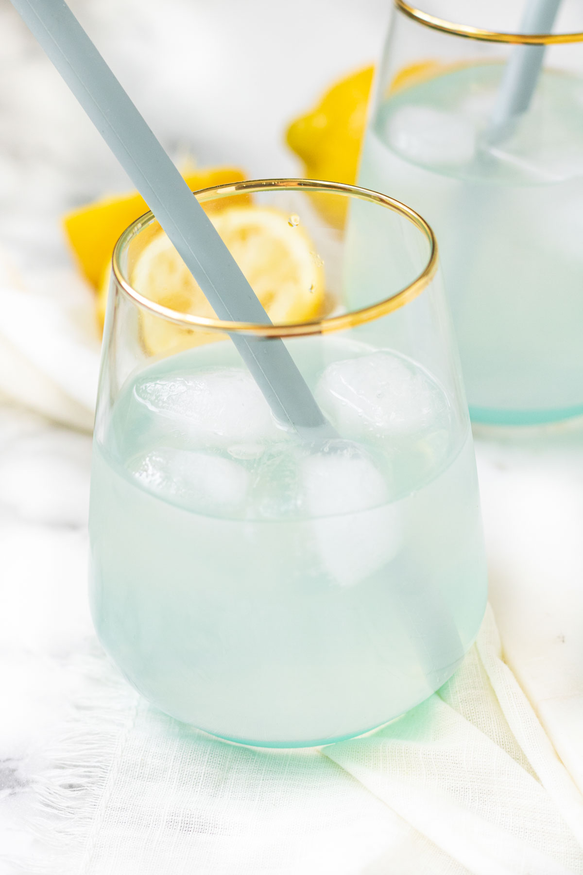 Lemonade in a glass with a straw.