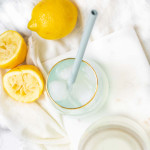 Lemonade in a glass with a straw.