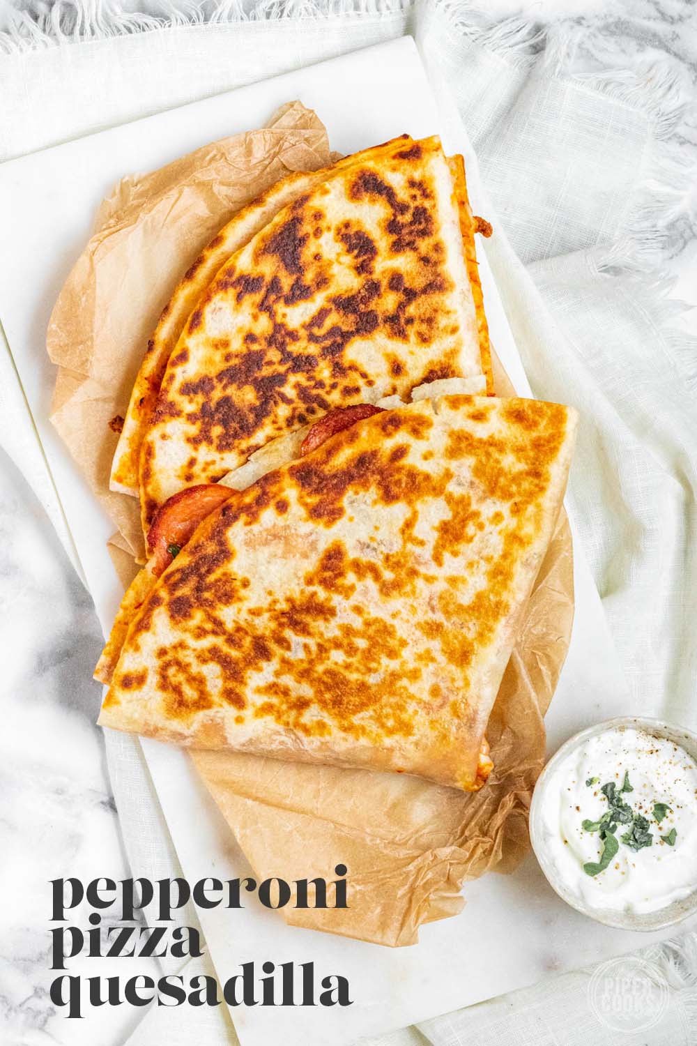 A folded pizza tortilla on a white board with text for Pinterest.