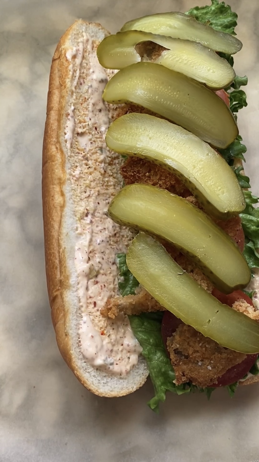 Pickles on a long sub bun.