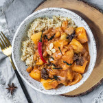 Massaman curry in a white and black speckled bowl.