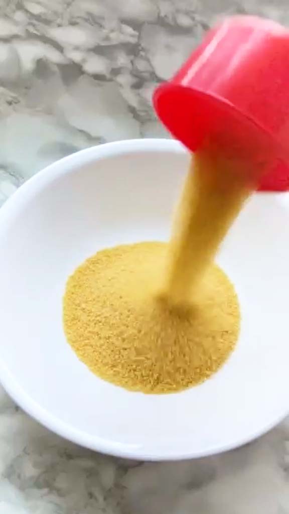 Adding dried couscous to a bowl.