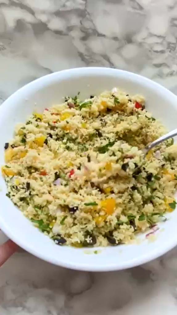 Couscous with chopped vegetables in a bowl.
