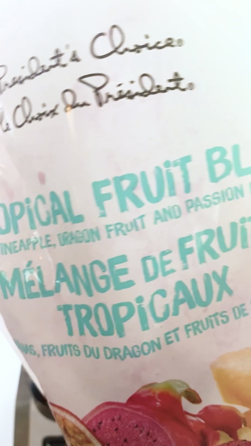A bag of frozen fruit blend of pineapple, dragon fruit and passion fruit.