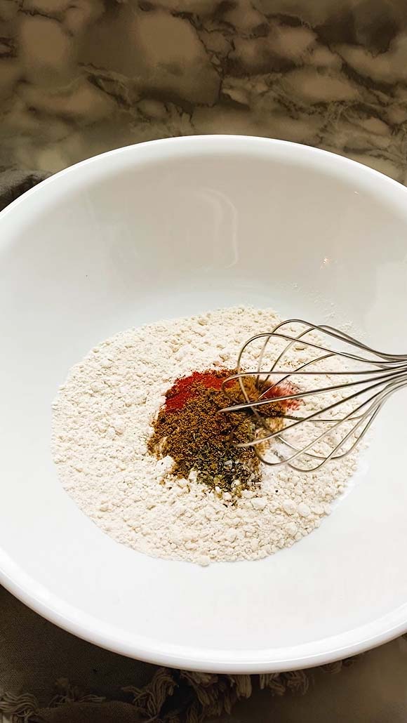 Whisking flour and spices together.