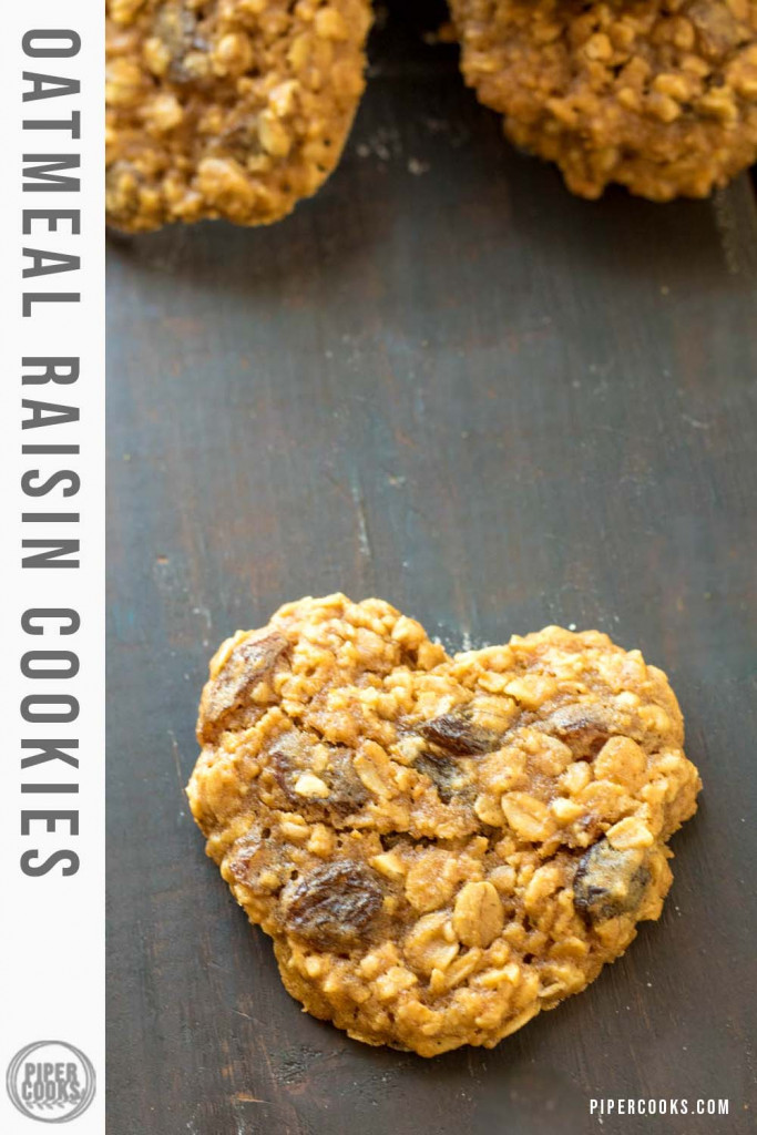 Heart shaped Oatmeal Raisin Cookies on a dark counter.