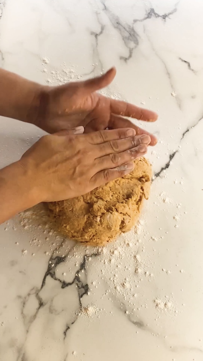 Patting scone dough flat.