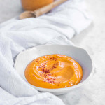 Orange gochujang aioli in a white bowl.