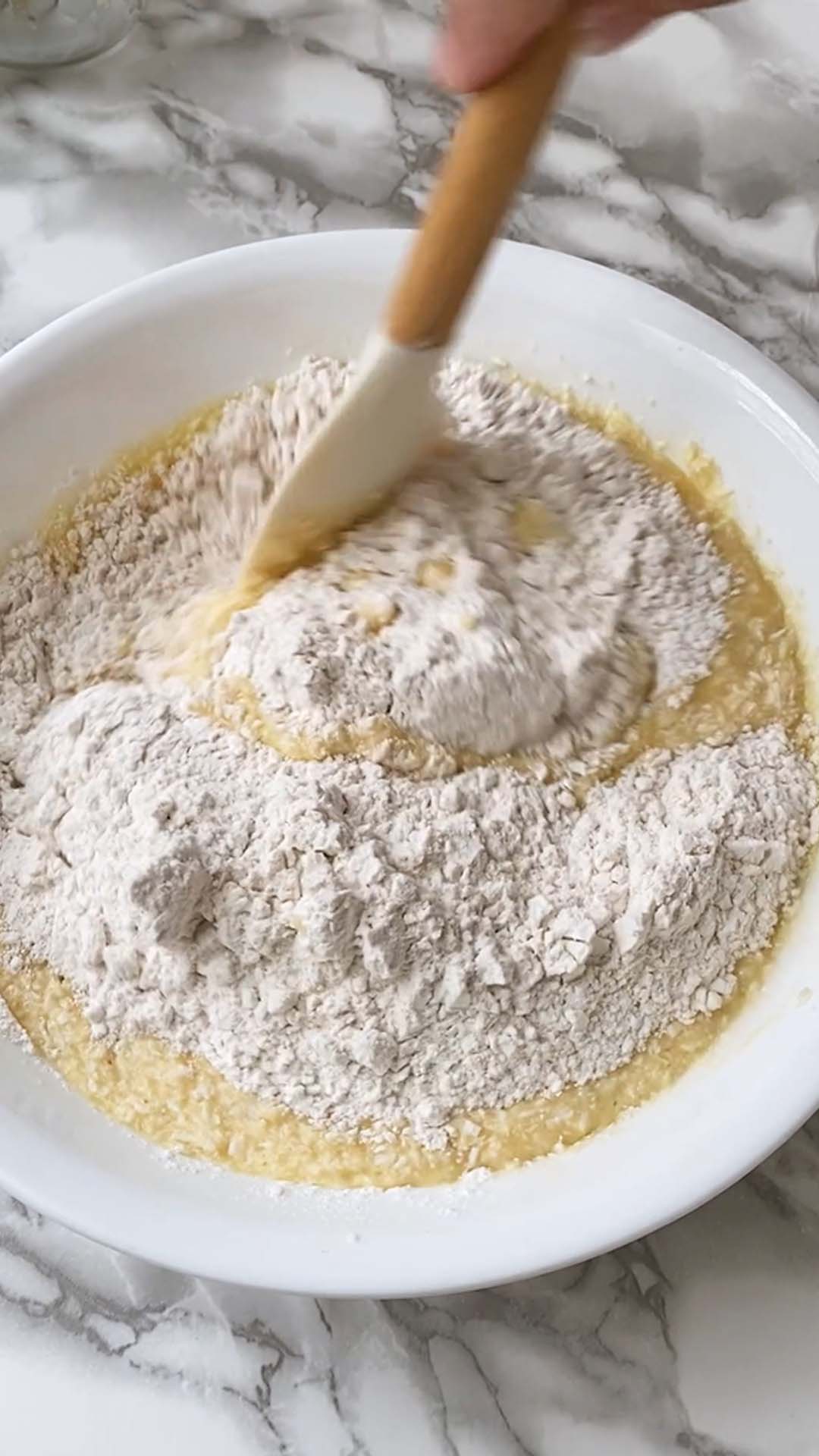 Stirring flour into cake batter.