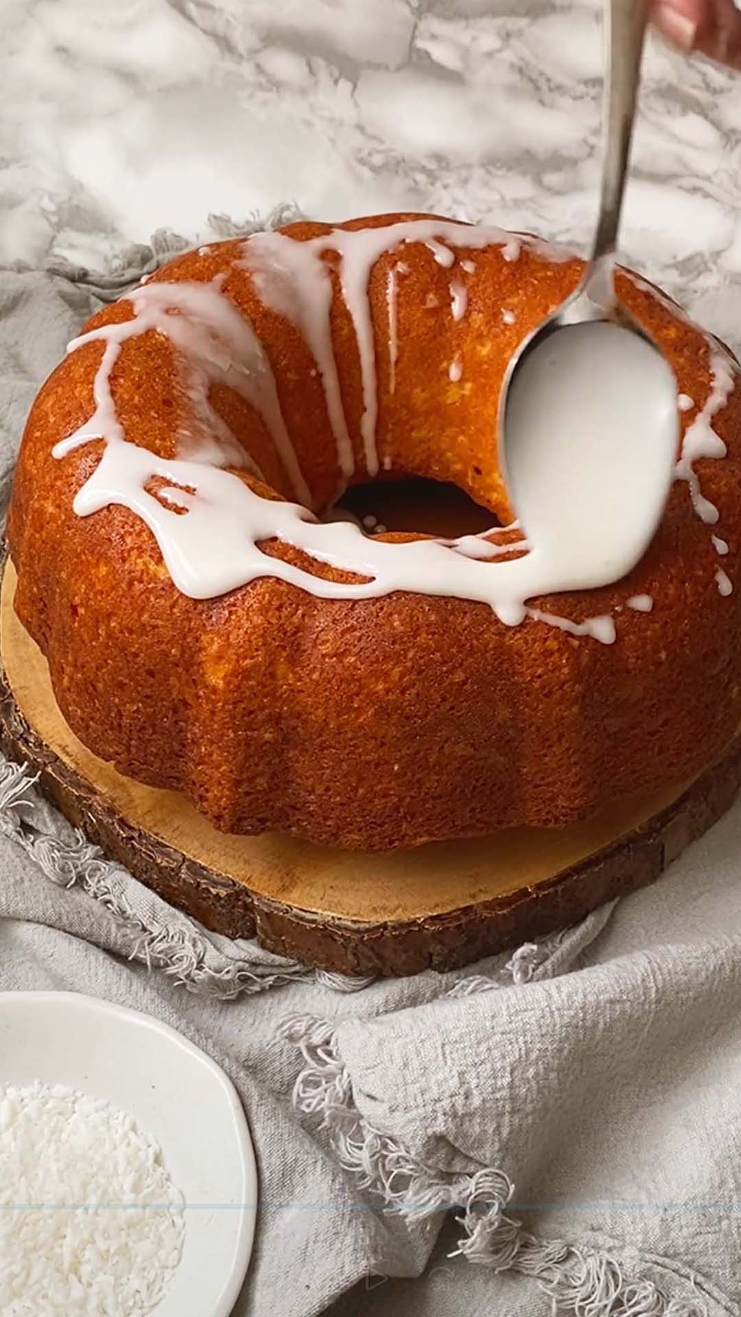 Adding icing on top of a bundt cake.